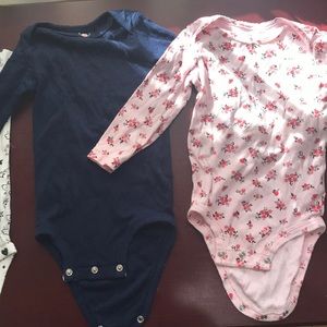 Set of three baby girl bodysuits
